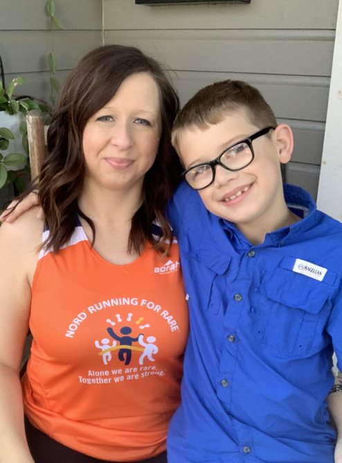 Lisa in a Running For Rare tank top with her son Zane who is wearing a blue shirt