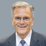 Peter S in grey suit portrait.
