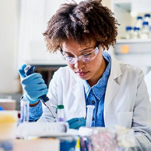 Young scientist analyzing sample in lab.