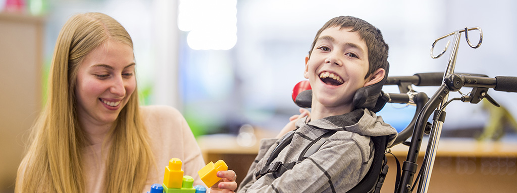 Happy little boy playing with toys