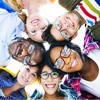 Diverse Group of People with their Heads Together Showing Friendship