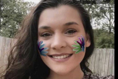 young girl smiling outdoors in park