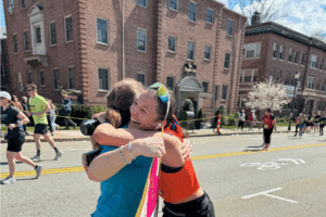 Kyra and Amanda hugging at the finish line