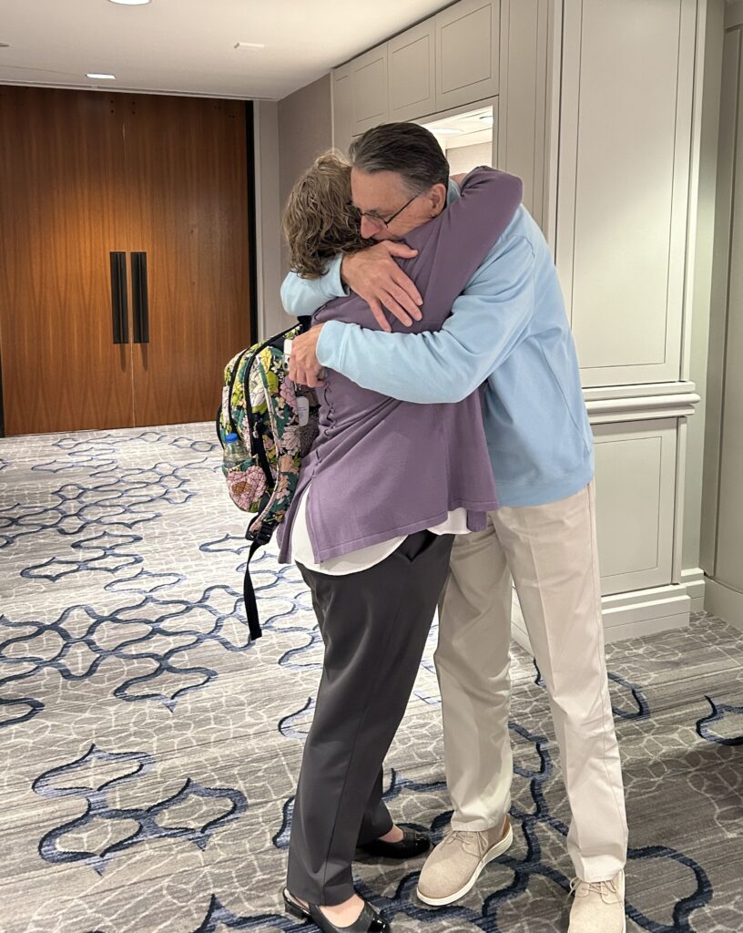 Shelley Bowen of the Barth Syndrome Foundation hugging another community member after her speech at the NORD Breakthrough Summit